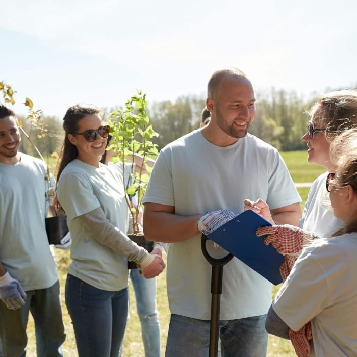 group-of-volunteers-with-tree-seedlings-in-park.jpg
